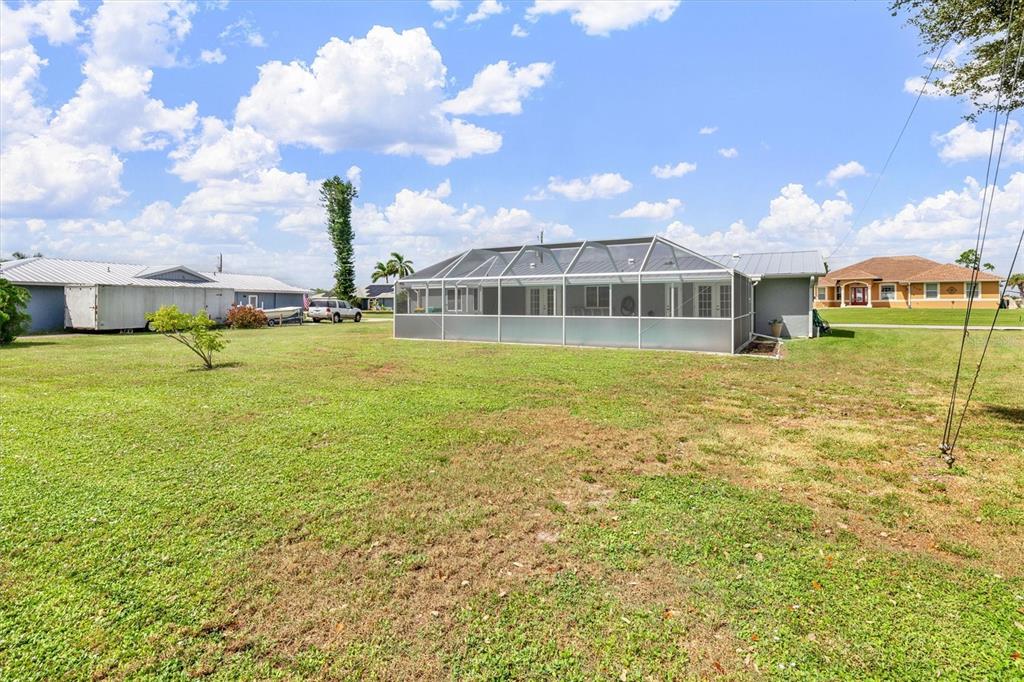 703 Spring Lake Boulevard Northwest Port Charlotte, FL 33952 - Photo 30 of 36 a view of an ocean with a house in the background