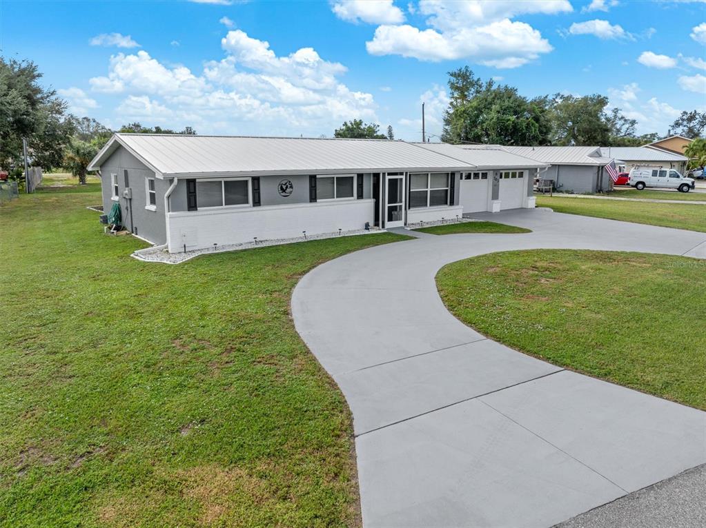 703 Spring Lake Boulevard Northwest Port Charlotte, FL 33952 - Photo 32 of 36 a view of a house with a big yard