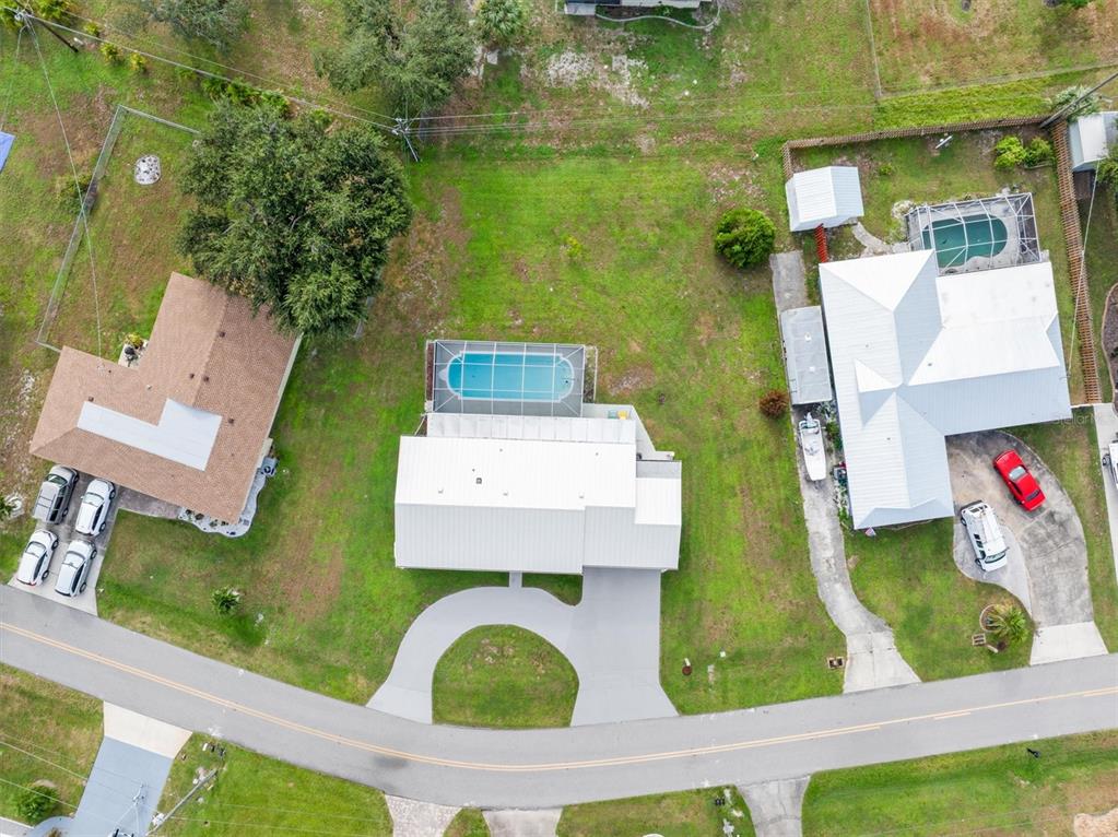 703 Spring Lake Boulevard Northwest Port Charlotte, FL 33952 - Photo 34 of 36 an aerial view of residential houses with outdoor space and swimming pool