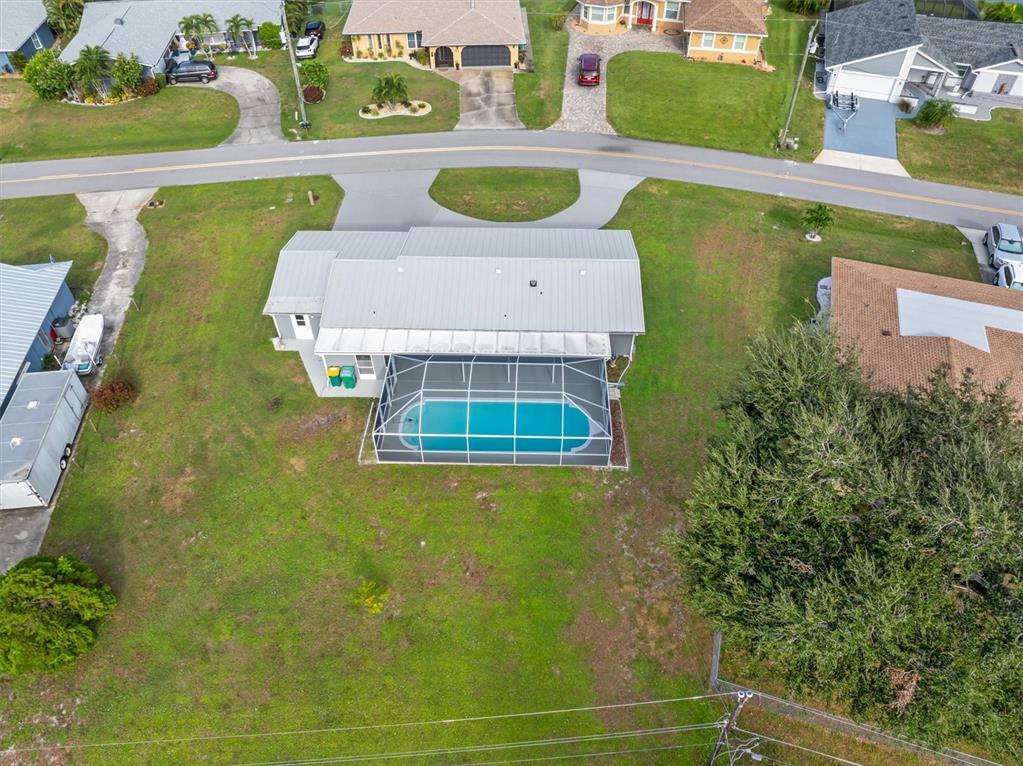 703 Spring Lake Boulevard Northwest Port Charlotte, FL 33952 - Photo 35 of 36 an aerial view of a house with a swimming pool