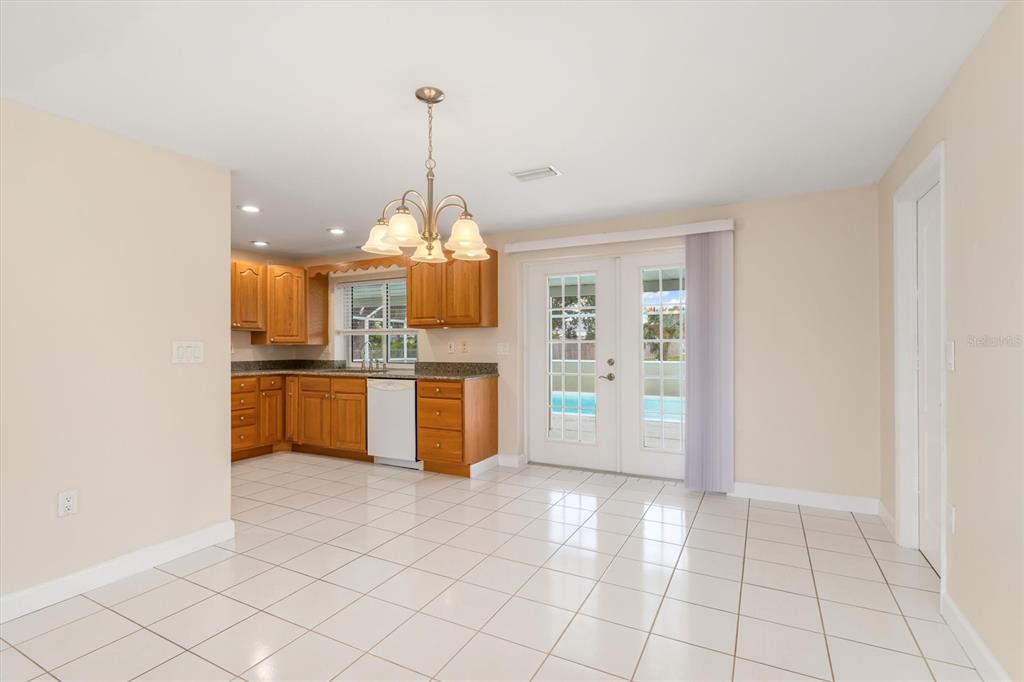 703 Spring Lake Boulevard Northwest Port Charlotte, FL 33952 - Photo 7 of 36 a view of a kitchen with microwave and cabinets