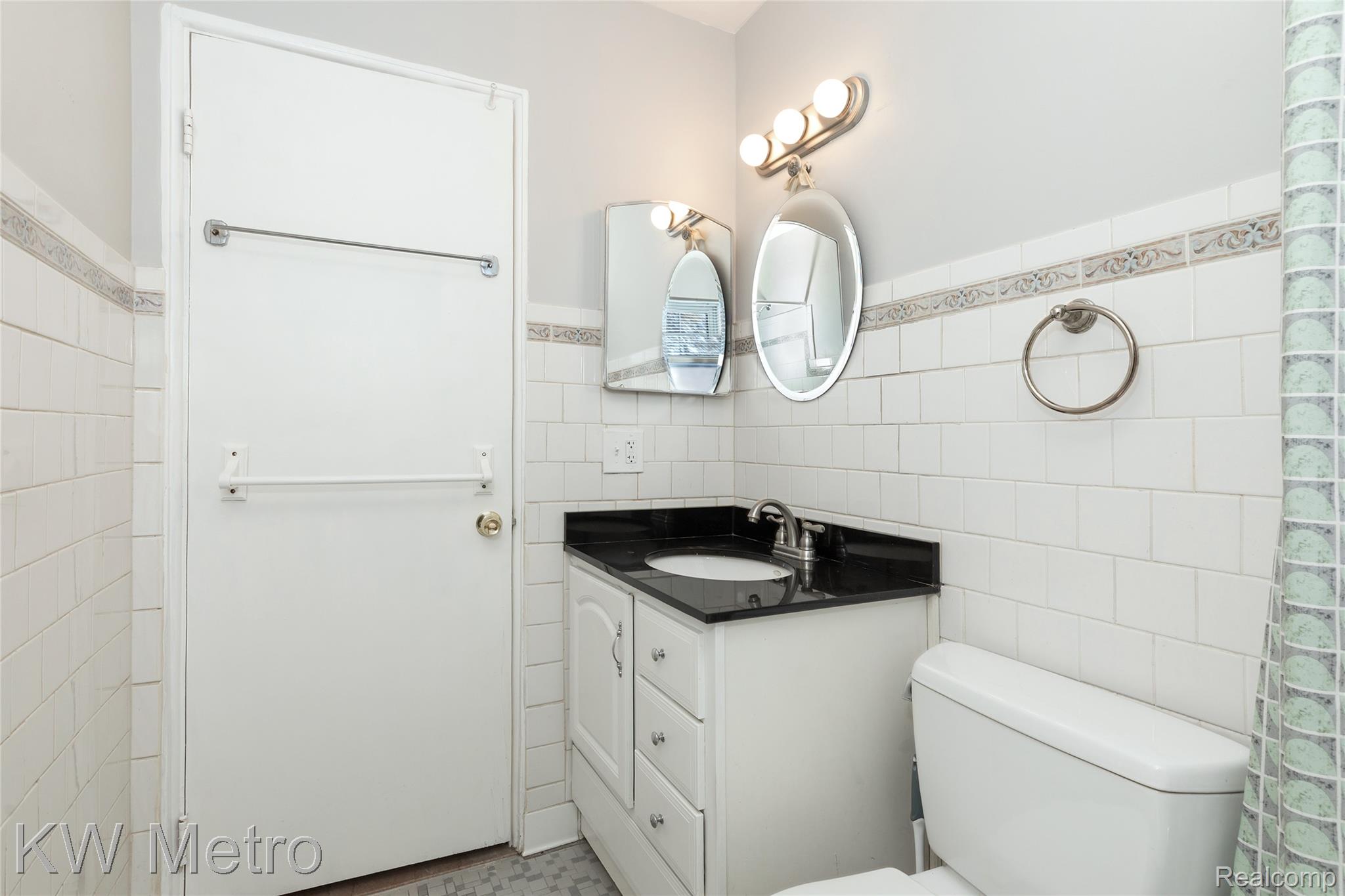 2817 West 13 Mile Road Royal Oak, MI 48073 - Photo 18 of 21 Bathroom with tile walls, a wainscoted wall, and vanity