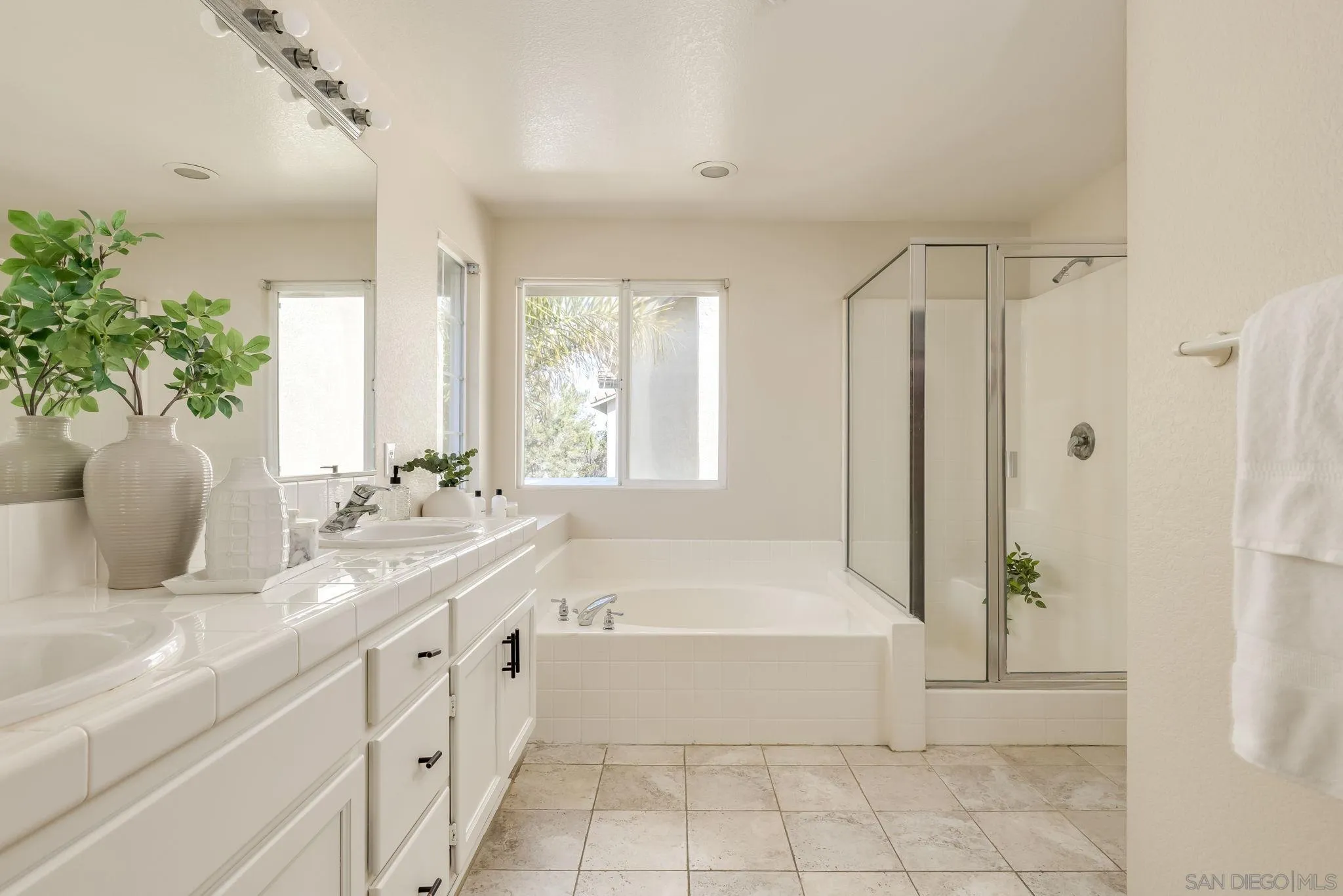 1589 Laurel Circle Vista, CA 92081 - Photo 17 of 31 a bathroom with a granite countertop bathtub a sink and a large mirror