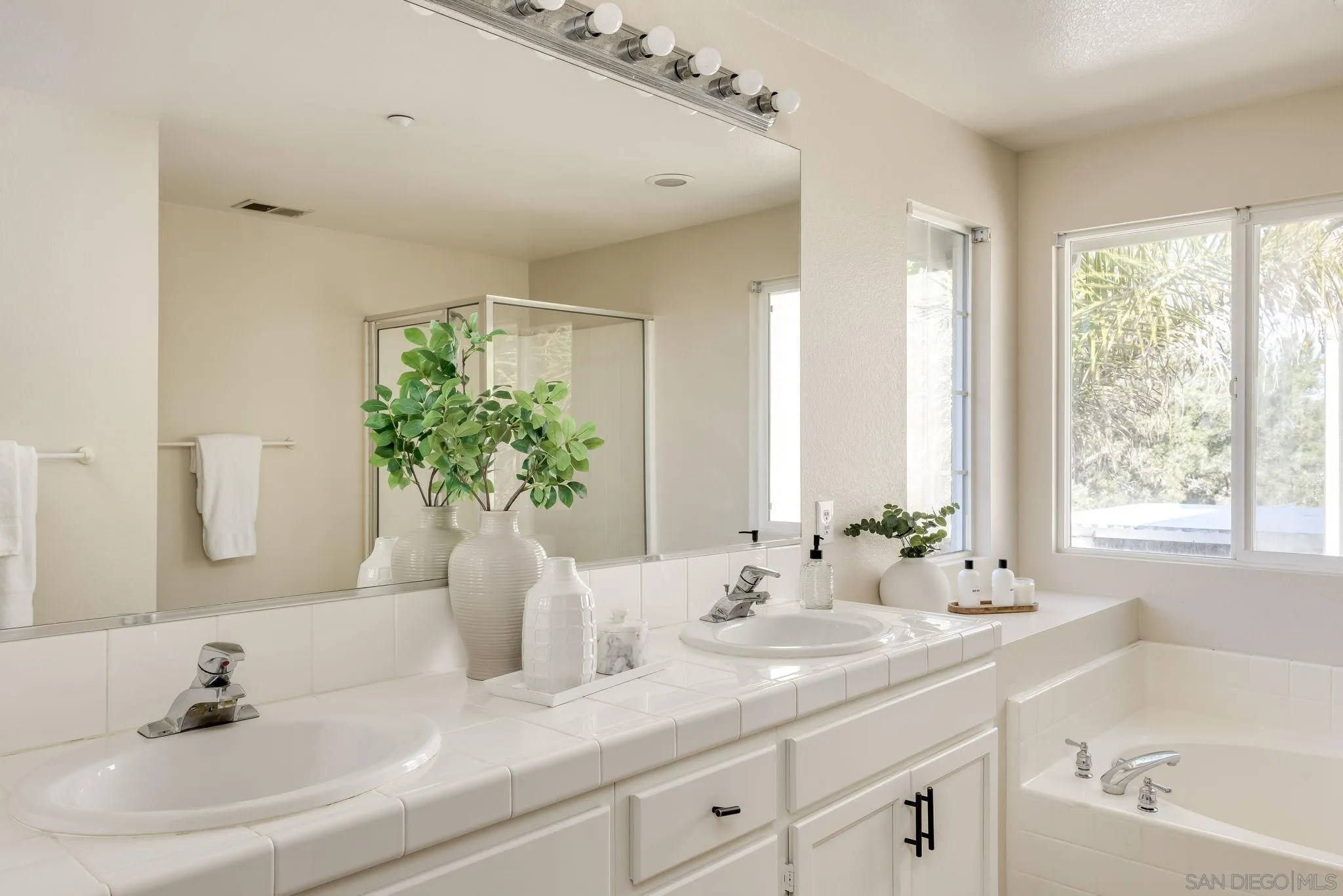 1589 Laurel Circle Vista, CA 92081 - Photo 18 of 31 a bathroom with a double vanity sink window and mirror