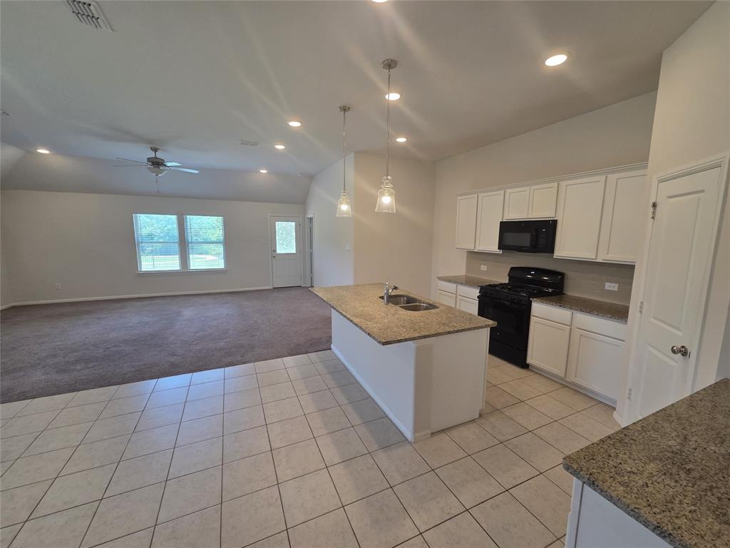 1512 Springtree Drive McKinney, TX 75071 - Photo 11 of 23 a kitchen with stainless steel appliances granite countertop a sink and a stove