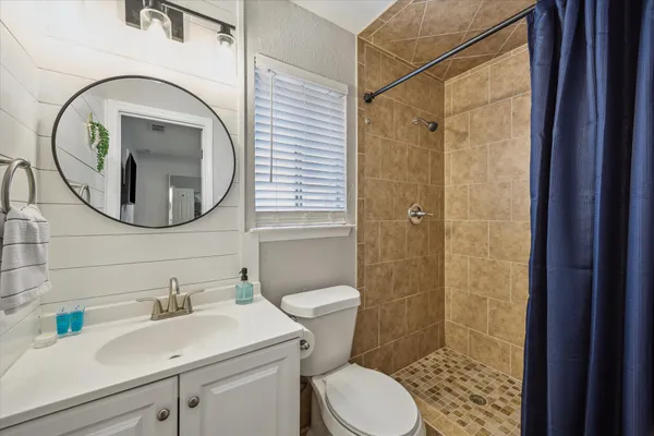 a bathroom with a sink a toilet and a mirror