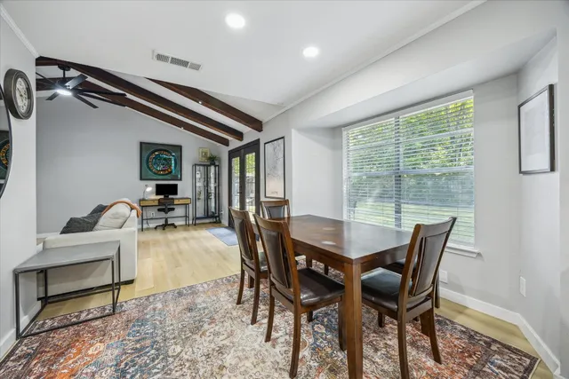a dining room with furniture and window