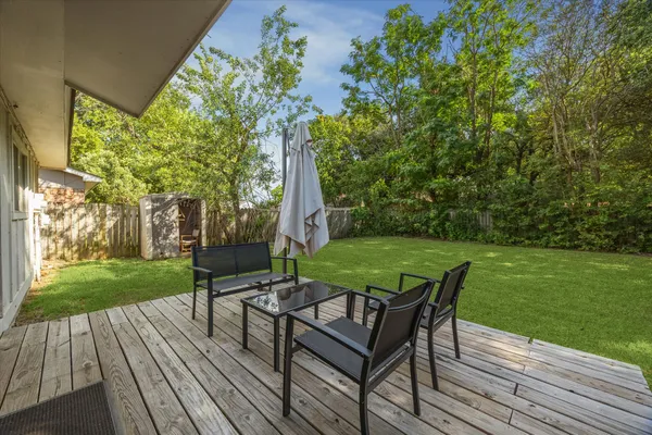 a view of a wooden deck and a yard