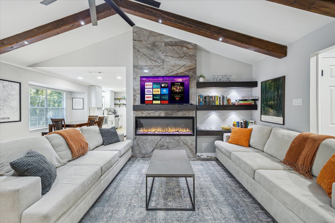 10414 Quail Ridge Drive Austin, TX 78758 - Photo 2 of 17 a living room with furniture and a fireplace
