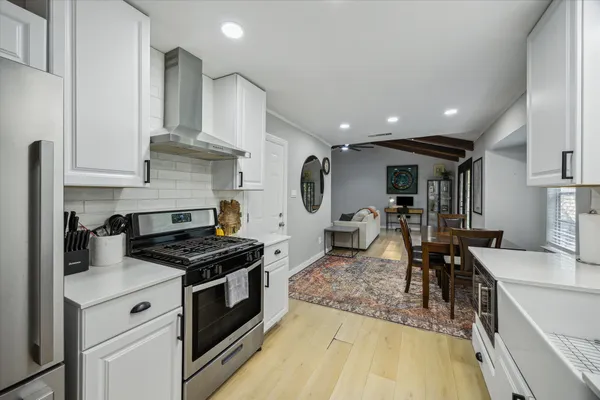 a kitchen with stainless steel appliances granite countertop a stove and a sink