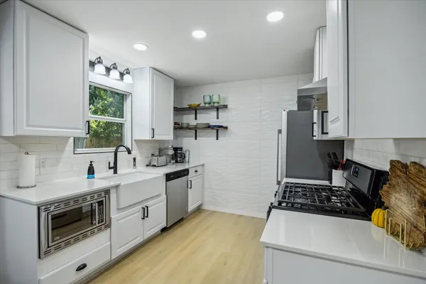 a kitchen with a stove a sink and a refrigerator