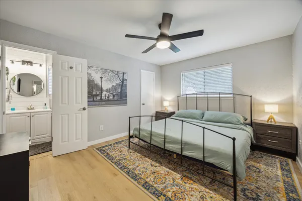 a bedroom with a large bed and a chandelier