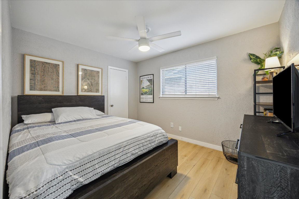 10414 Quail Ridge Drive Austin, TX 78758 - Photo 10 of 17 a bedroom with a bed and a flat screen tv
