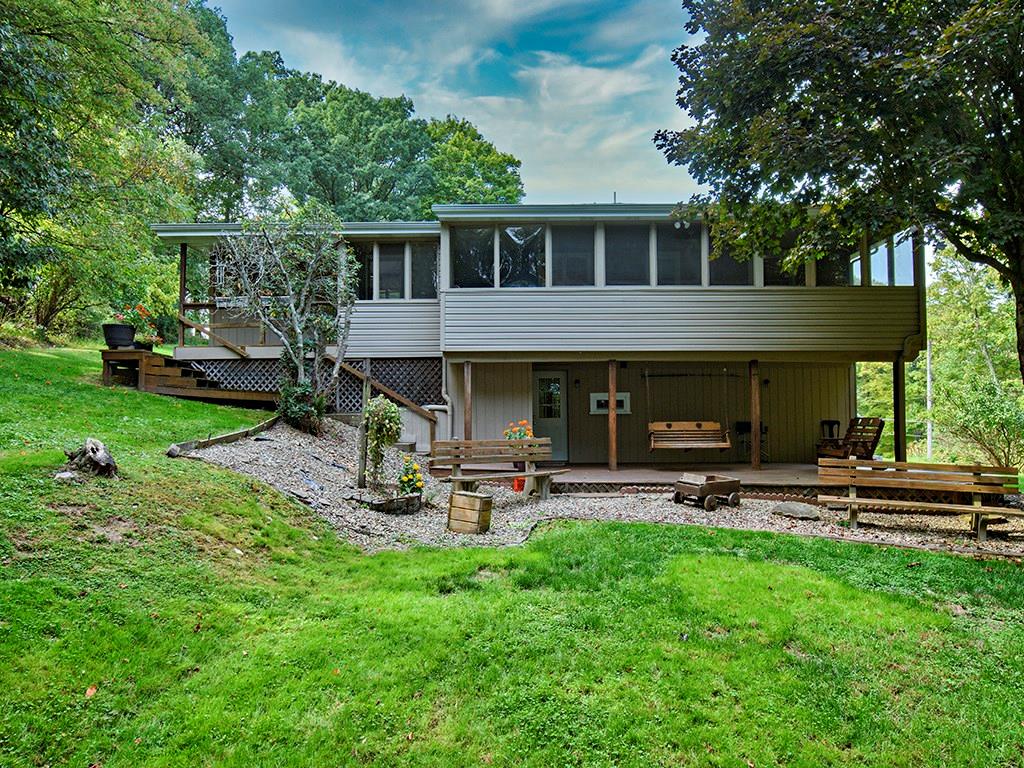 413 Spring St Extension Mars, PA 16046 - Photo 8 of 22 Rear View of Home. Sit on your 27 Foot Covered Deck, Enjoy the View and Nature. The door on the lower level, takes you to your Storage and Laundry Room. Above is a 31 Foot Sunroom. You'll see an interior picture soon. There is also a Full Bathroom, Bedroom and Family Room with Fireplace on the Lower Level, which you can access from the Front or Rear of Home.