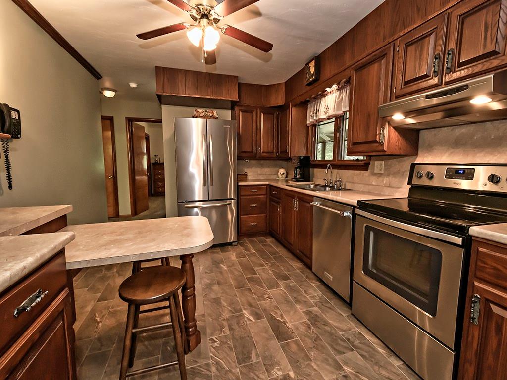 413 Spring St Extension Mars, PA 16046 - Photo 10 of 22 Kitchen 14 X 10 Feet. Yes, The SS Appliances Stay. Porcelain Tile Plank Flooring, Loads of Storage!