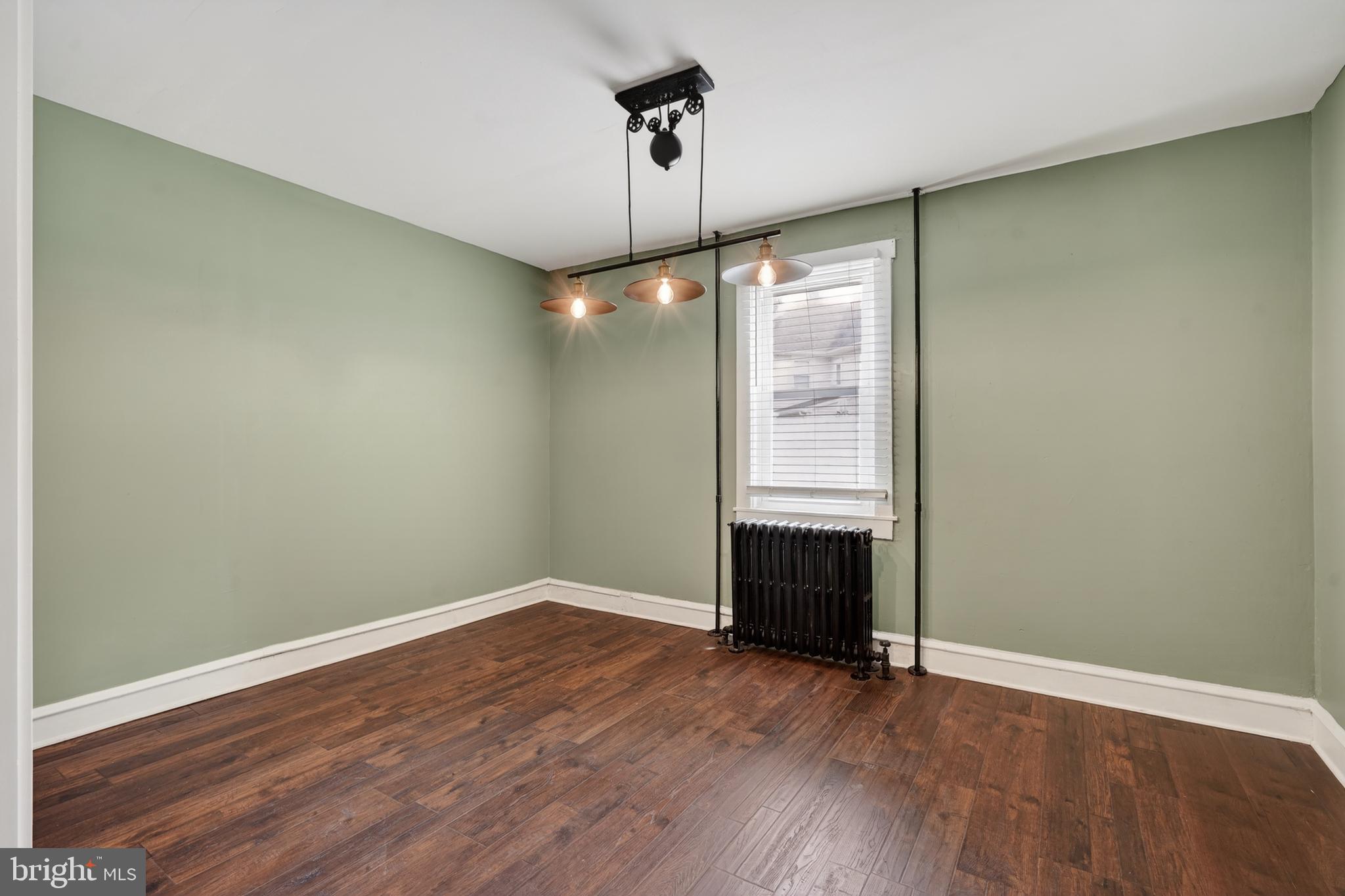 223 Noreg Place Brooklawn, NJ 08030 - Photo 13 of 36 wooden floor in an empty room with a window