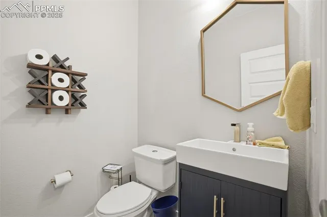 a bathroom with a sink mirror and toilet