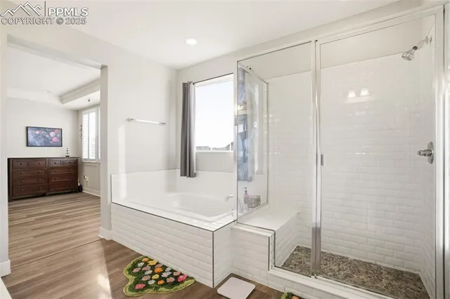 a bathroom with a bathtub and a shower