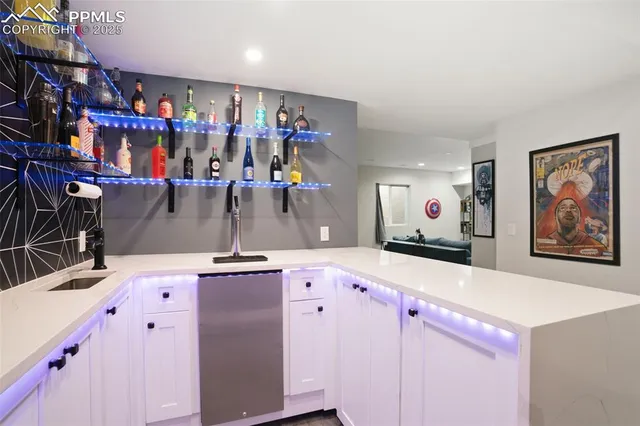a view of kitchen with stainless steel appliances kitchen island granite countertop a sink and cabinets