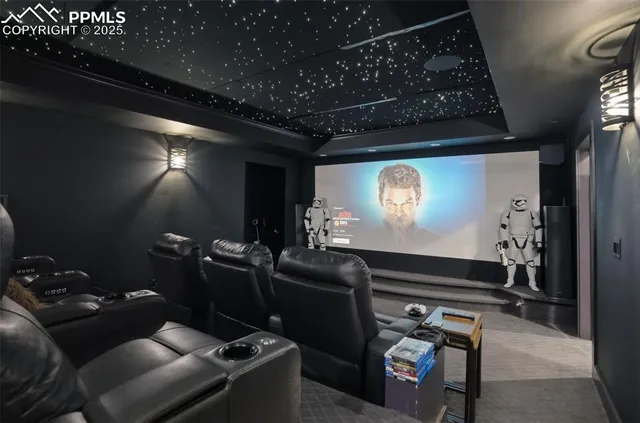a room with furniture projector and screen