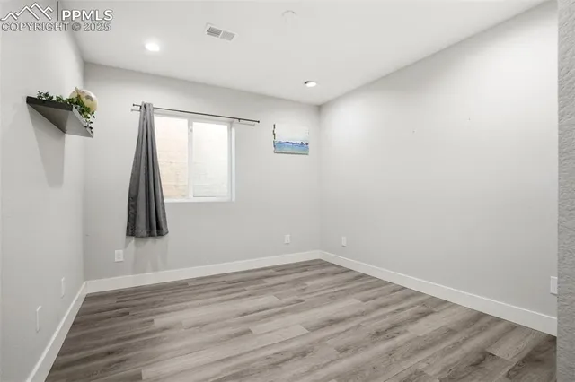 a view of room with window and wooden floor