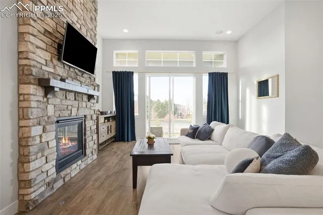 a living room with fireplace furniture and a flat screen tv
