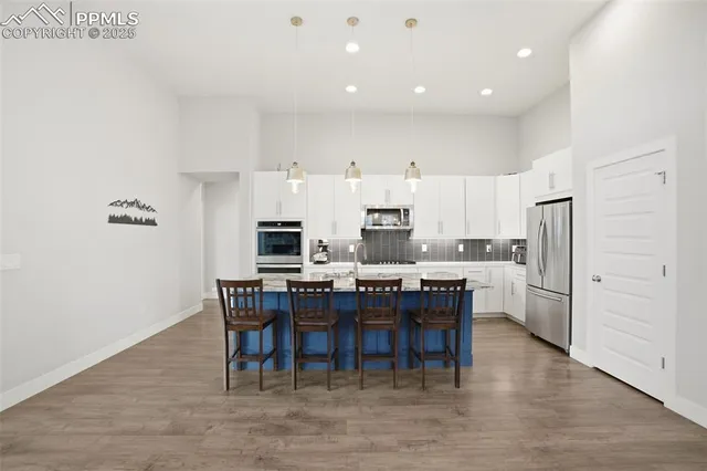 a kitchen with kitchen island granite countertop wooden cabinets and counter space