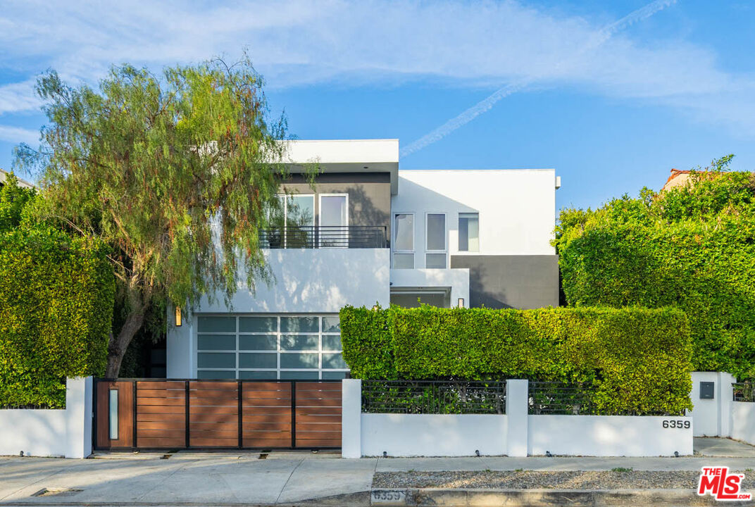 a view of front door and potted plants