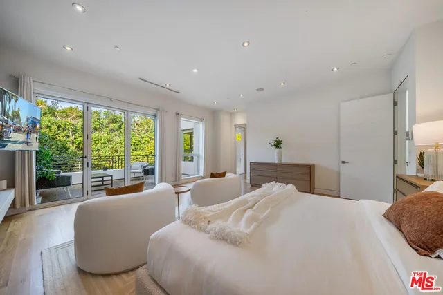 a bedroom with a large bed and a large window