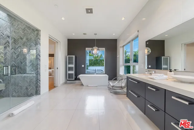 a large bathroom with a large tub and sink
