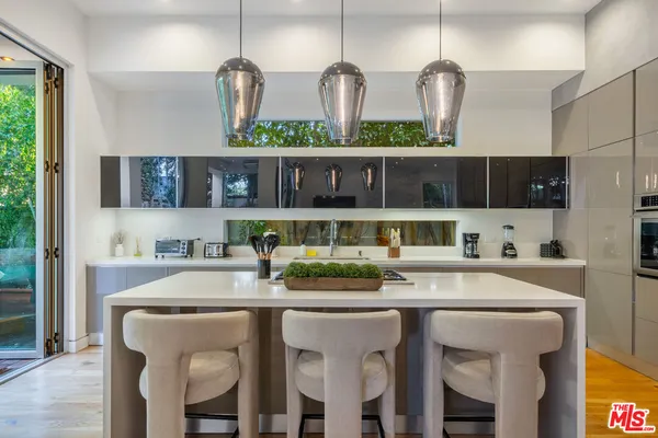 a dining table with chairs and cabinets