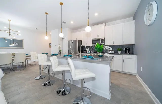 a large kitchen with a table and chairs