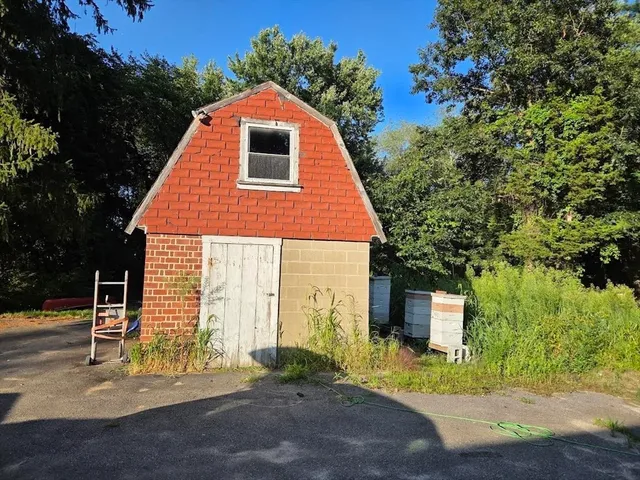 a backyard of a house with table and chairs