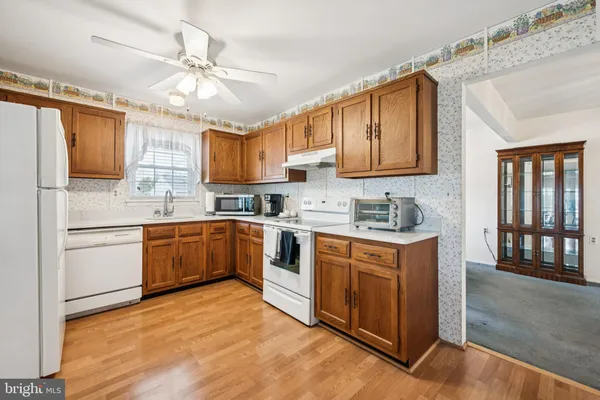 a kitchen with stainless steel appliances granite countertop a sink cabinets and window