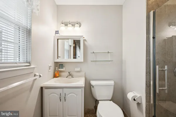 a bathroom with a toilet sink and mirror