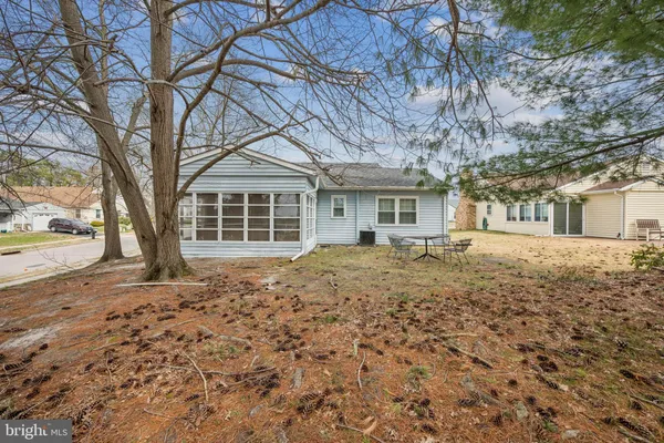 front view of a house with a large tree