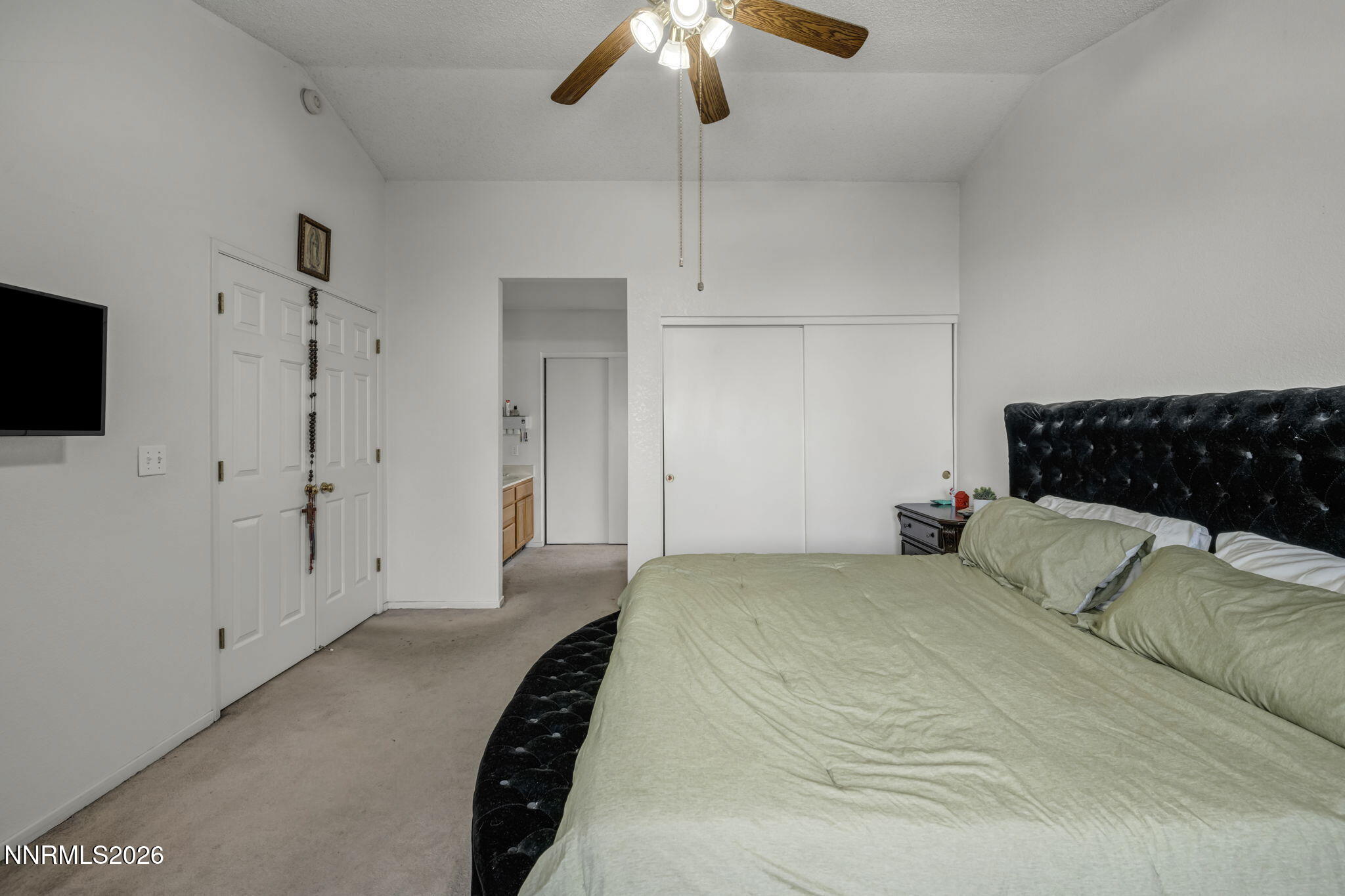 8655 Silver Shores Drive Reno, NV 89506 - Photo 23 of 42 a bedroom with a bed and a chandelier
