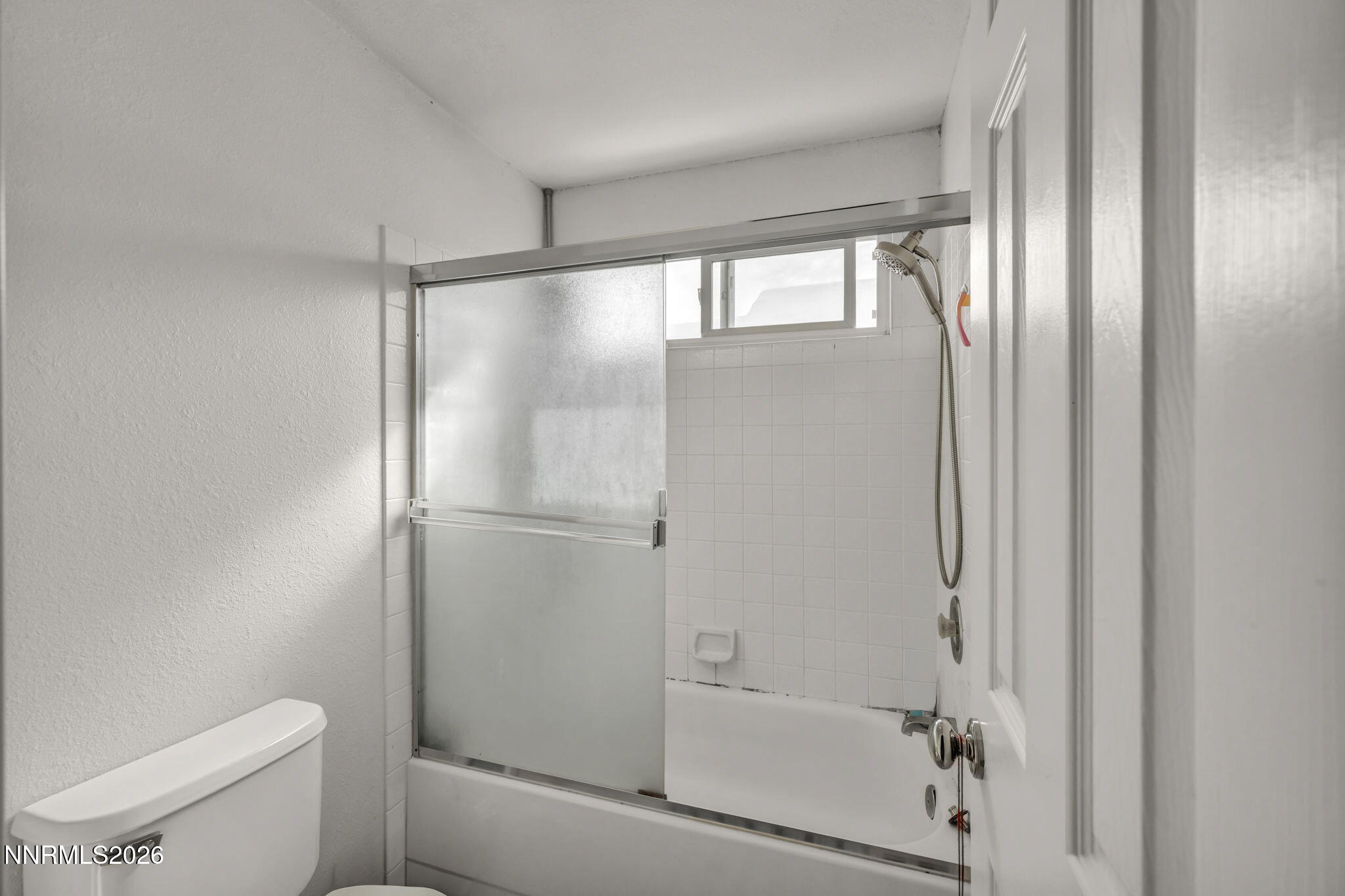 8655 Silver Shores Drive Reno, NV 89506 - Photo 25 of 42 a bathroom with a glass shower door