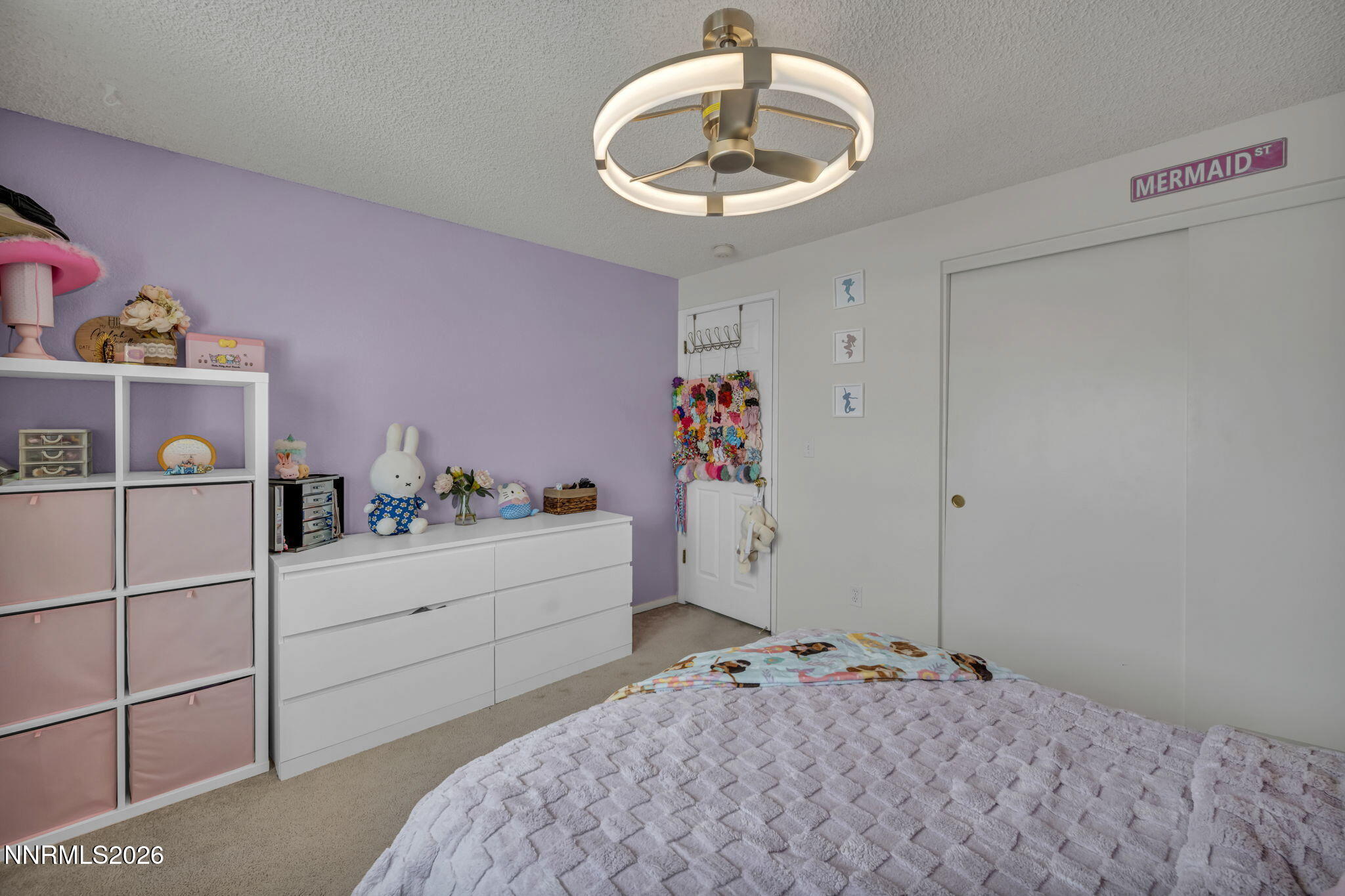 8655 Silver Shores Drive Reno, NV 89506 - Photo 30 of 42 a bedroom with a bed and a chandelier