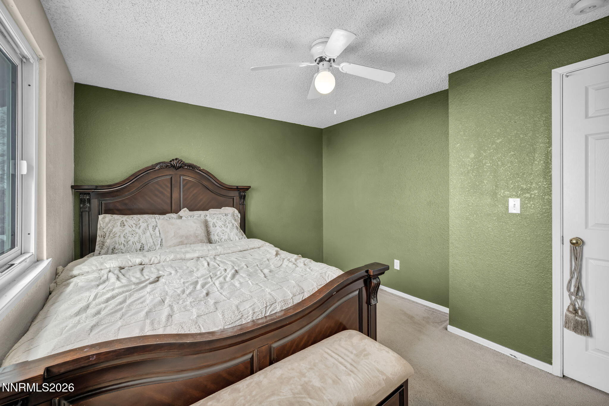 8655 Silver Shores Drive Reno, NV 89506 - Photo 32 of 42 a bedroom with a bed and a chandelier