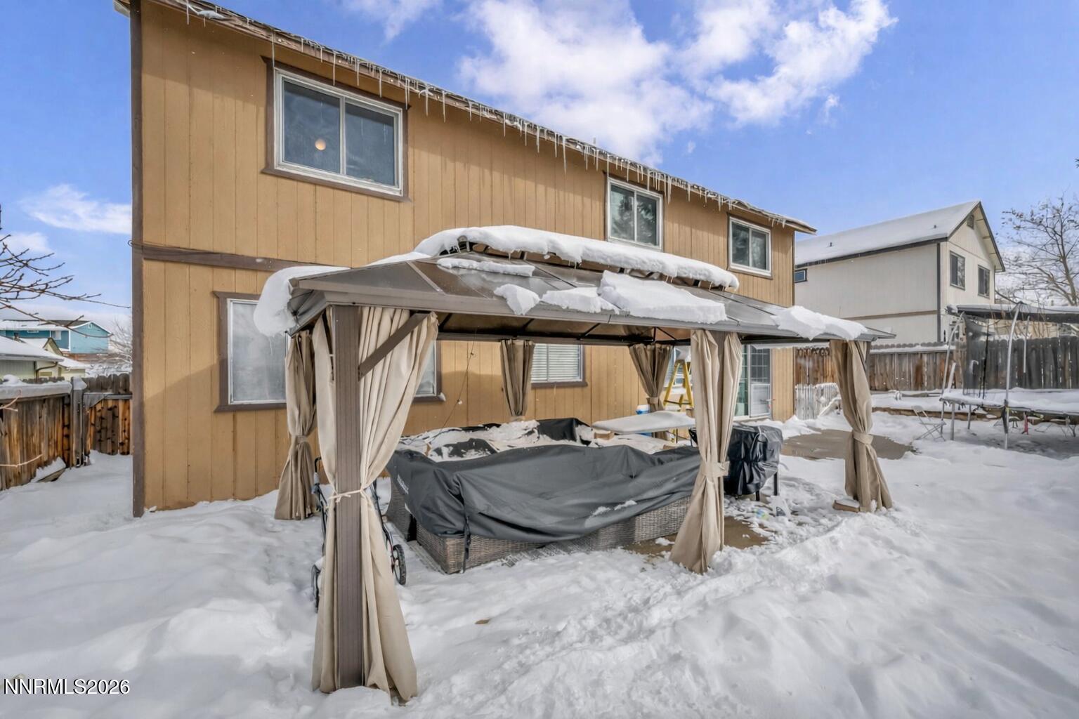 8655 Silver Shores Drive Reno, NV 89506 - Photo 38 of 42 a patio with a table and chairs under an umbrella