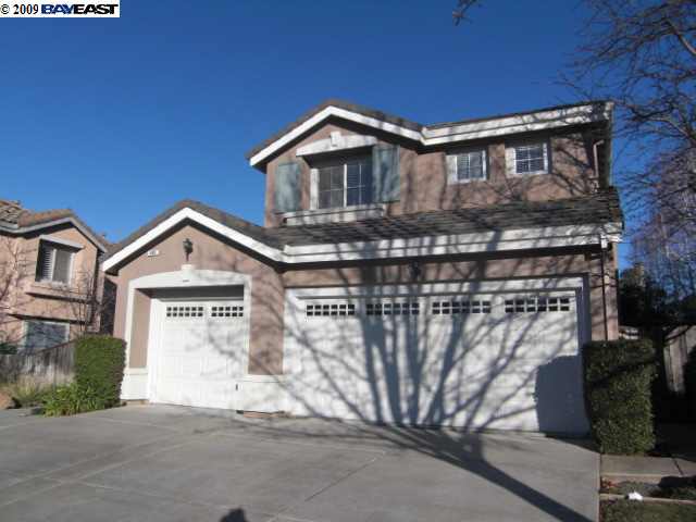 a front view of a house with parking space