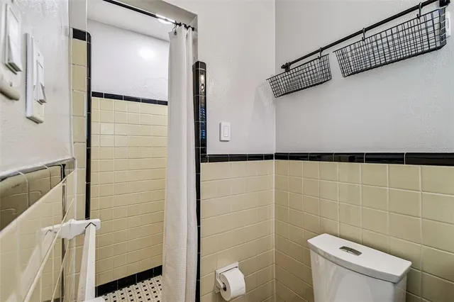a bathroom with a shower and toilet