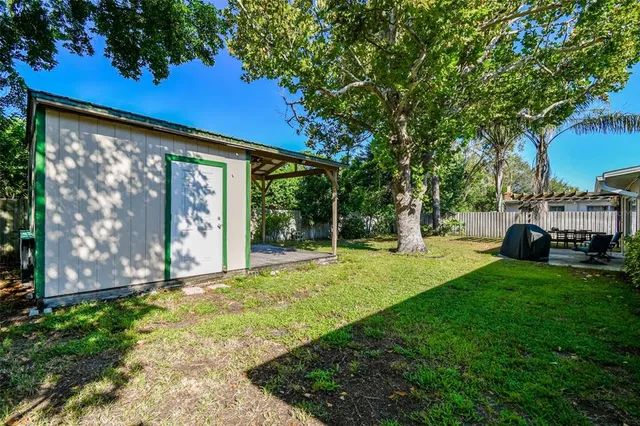a view of a house with backyard and sitting area