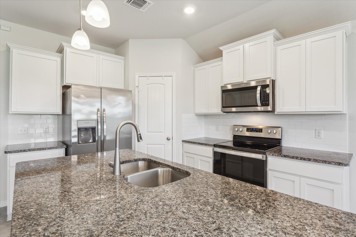 5830 Copano Road Belton, TX 76513 - Photo 16 of 34 Kitchen featuring a sink, white cabinetry, visible vents, and stainless steel appliances