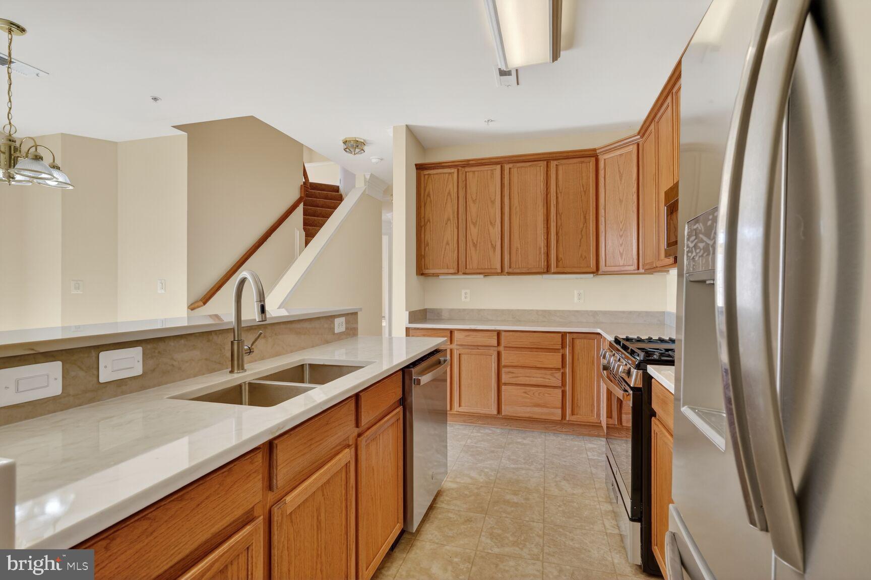 13210 Rabbit Chase Road Laurel, MD 20707 - Photo 14 of 40 a kitchen with a sink a counter top space and cabinets