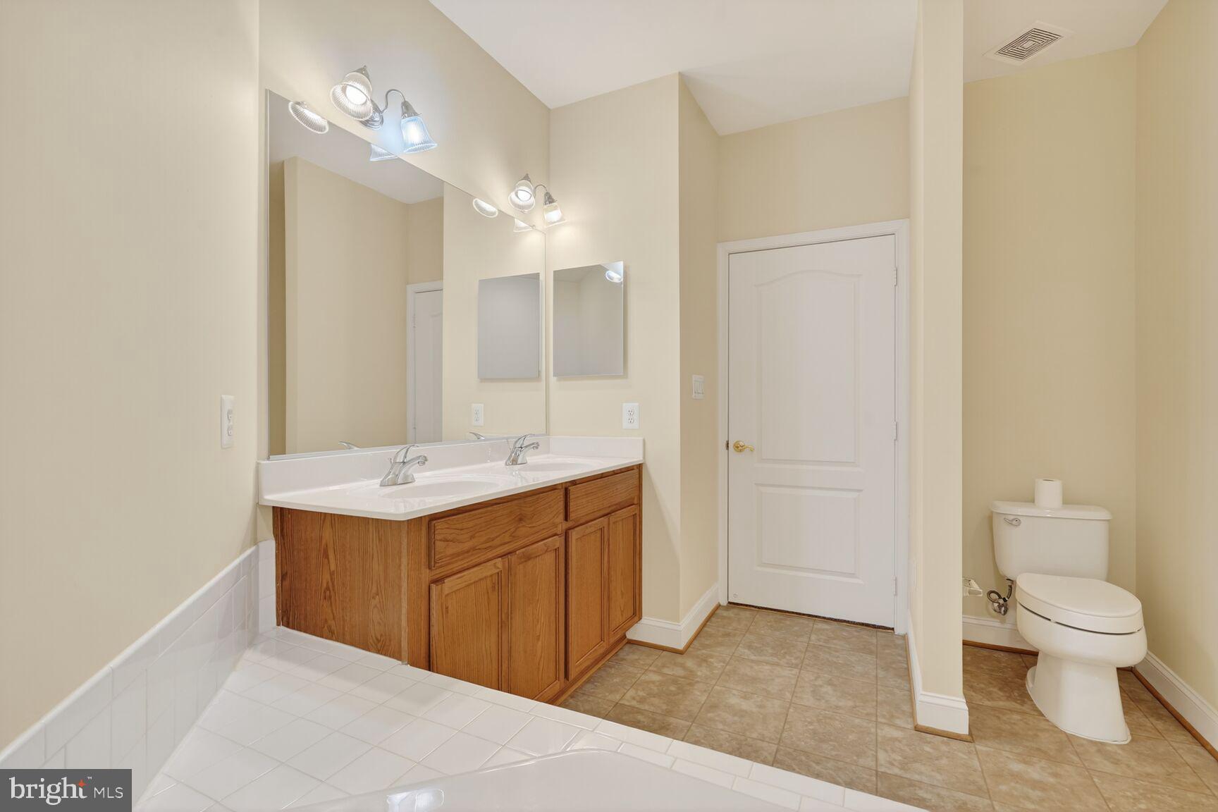 13210 Rabbit Chase Road Laurel, MD 20707 - Photo 20 of 40 a bathroom with a sink a toilet and shower