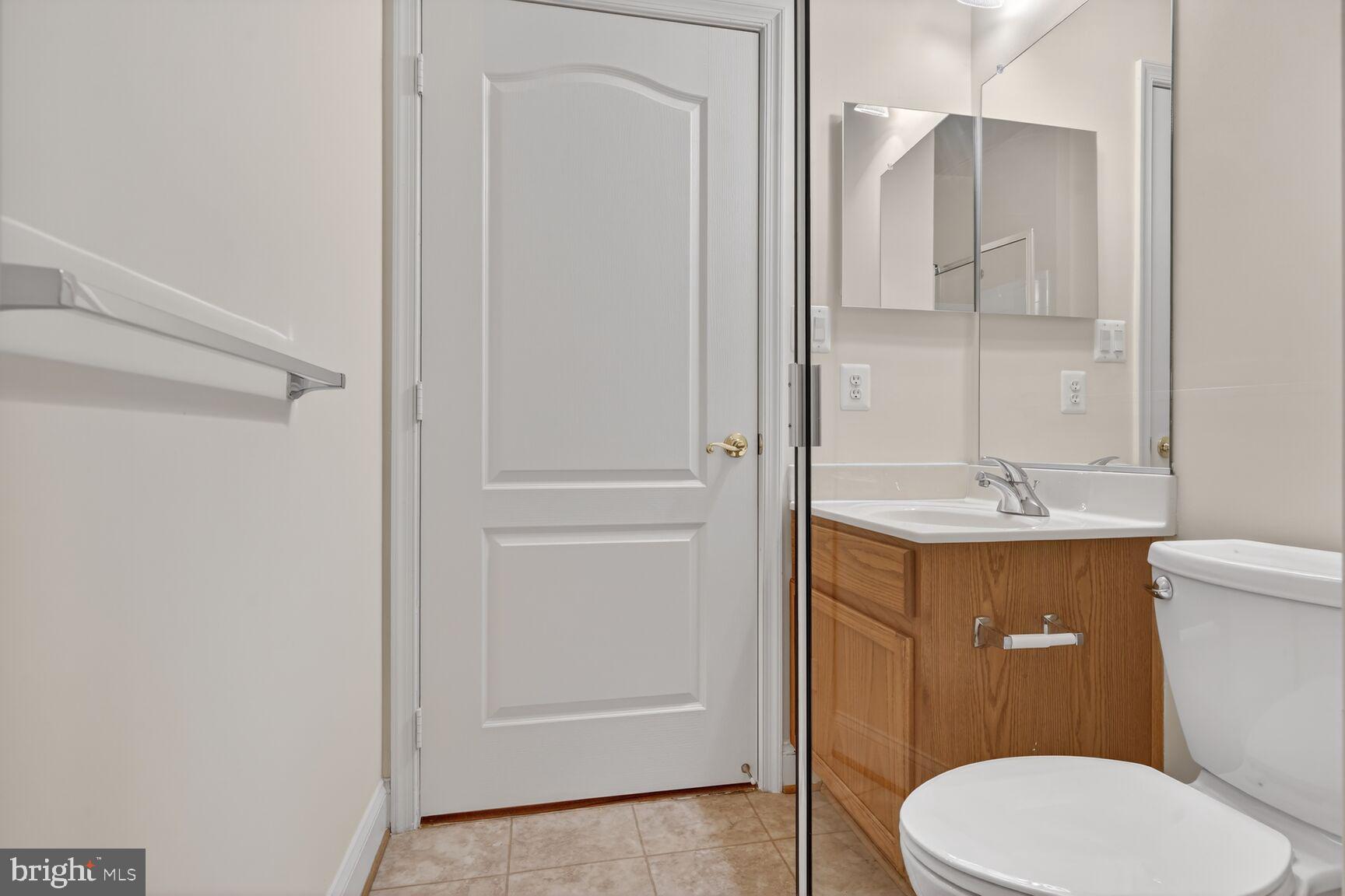 13210 Rabbit Chase Road Laurel, MD 20707 - Photo 23 of 40 a bathroom with a toilet a sink and a mirror