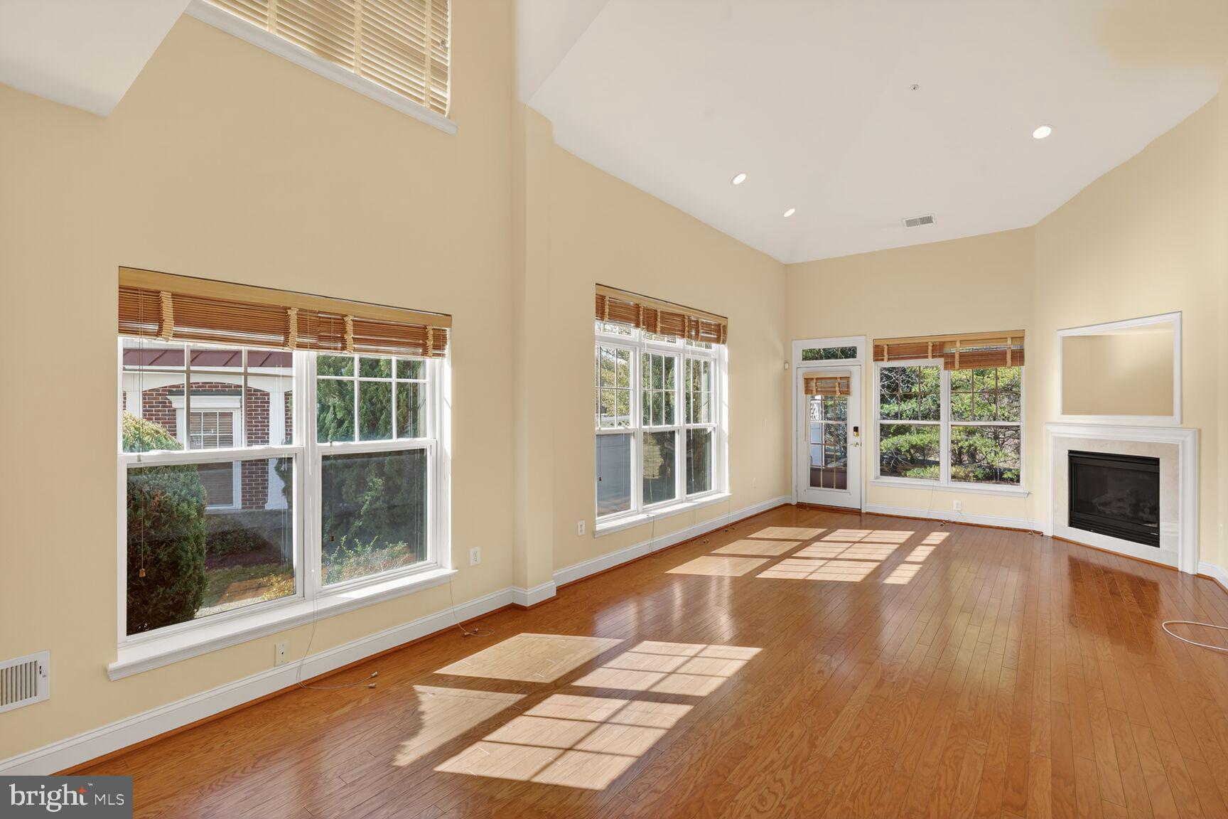 13210 Rabbit Chase Road Laurel, MD 20707 - Photo 8 of 40 a view of an empty room with wooden floor and a window