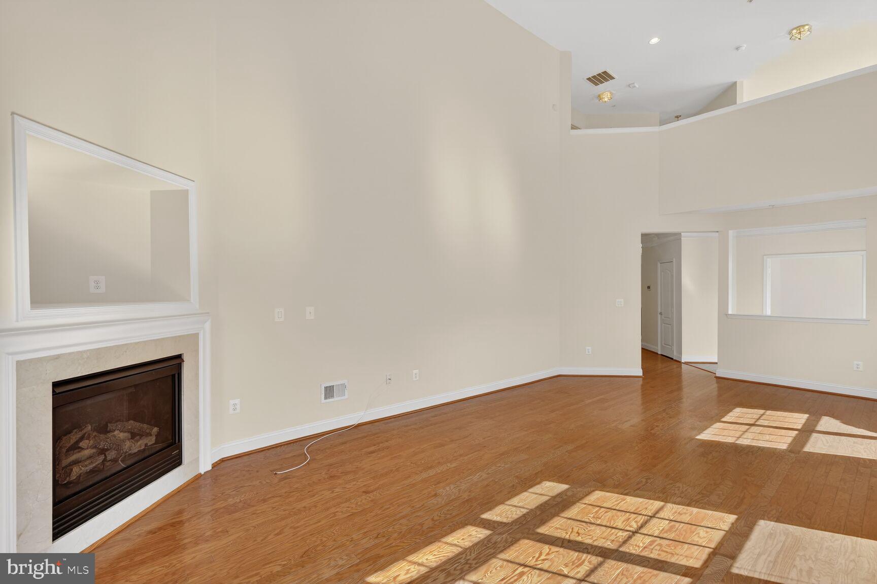 13210 Rabbit Chase Road Laurel, MD 20707 - Photo 9 of 40 a view of empty room with wooden floor and fireplace